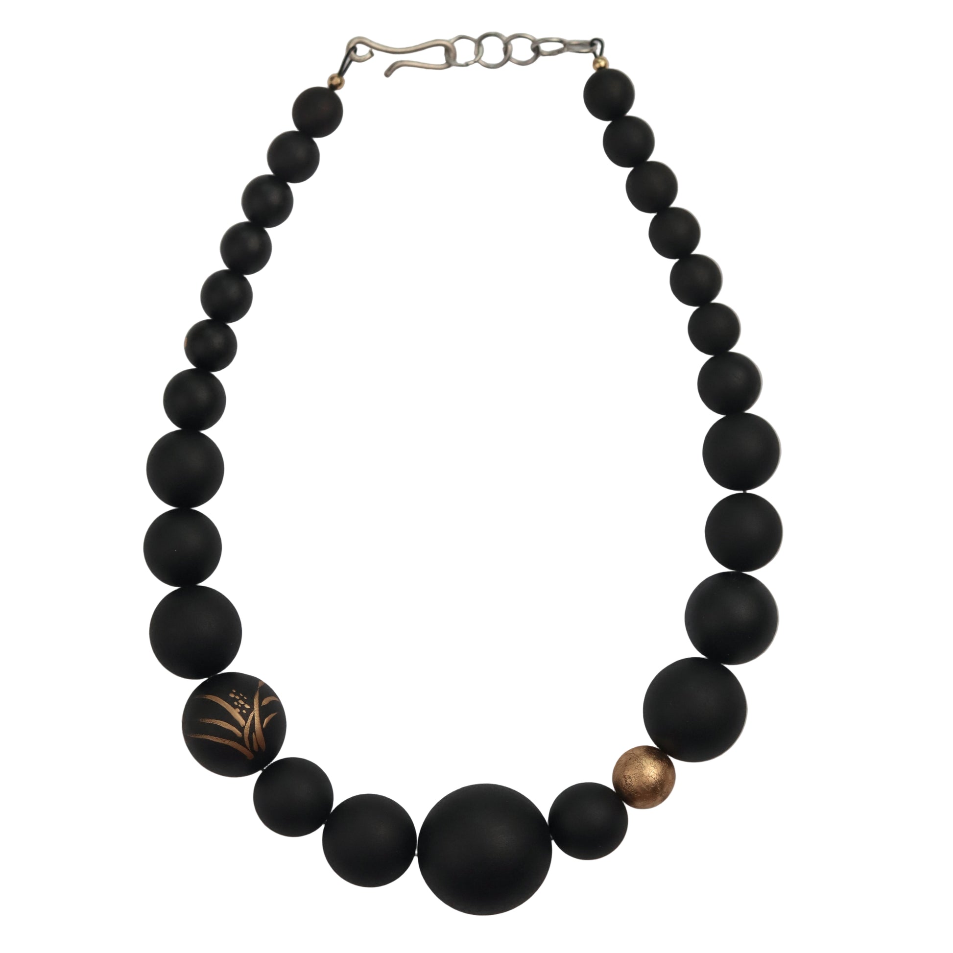Black beaded necklace with gold accents on a white background