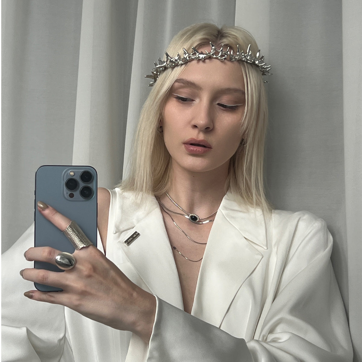 Amazon · Dome Ring — Woman in a white outfit with jewelry taking a mirror selfie against a plain background