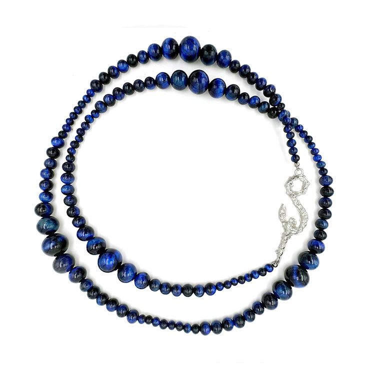 Amazon · Snakebone S-Hook Tiger’s Eye Long Necklace — Blue beaded necklace with a silver clasp on a white background
