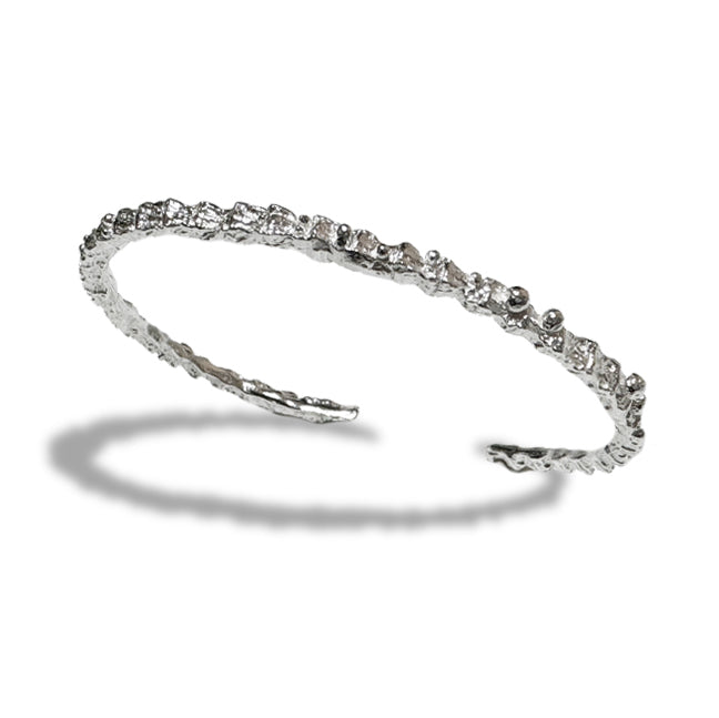 Amazon · Snakebone Silver Bangle Bracelet — Silver headband with small stones on a white background