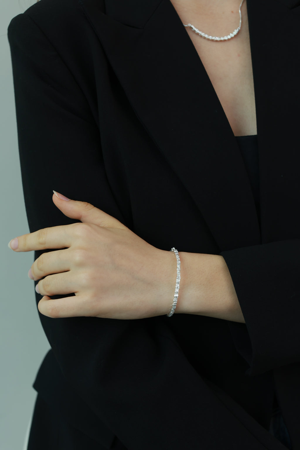 Amazon · Snakebone Silver Bangle Bracelet — Person wearing a silver bracelet on a plain background