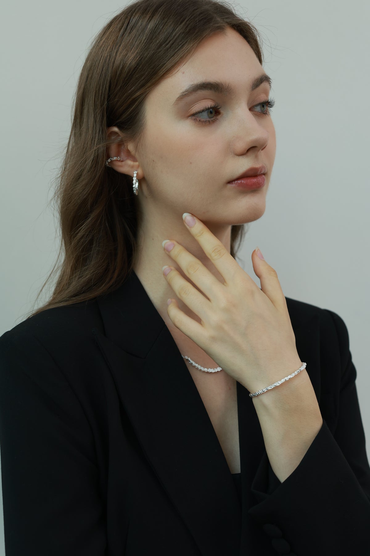 Amazon · Snakebone Silver Bangle Bracelet — Woman wearing a black outfit with a plain background