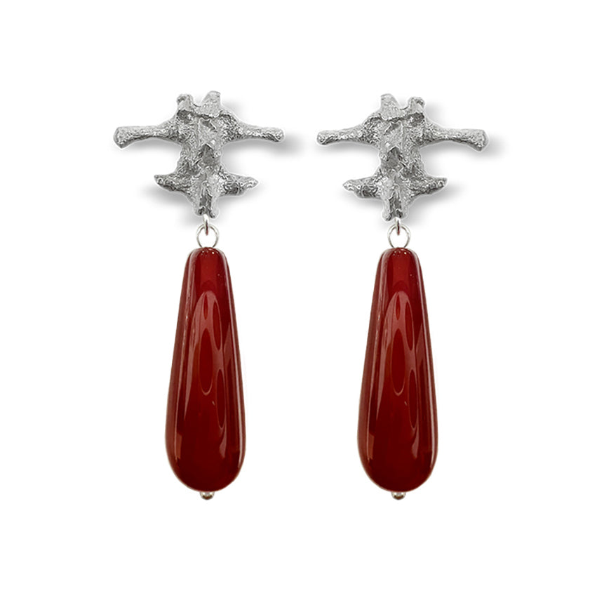 Amazon · Spine & Quartz Raindrop Earrings — Pair of earrings with star-shaped top and teardrop-shaped red stone on a white
