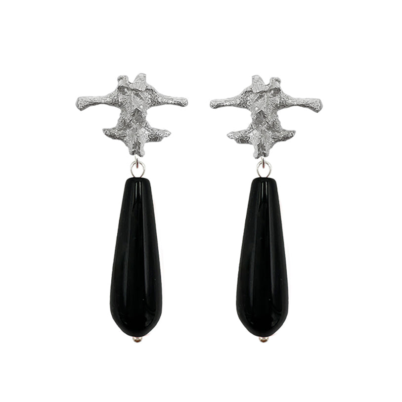 Amazon · Spine & Quartz Raindrop Earrings — Pair of earrings with silver star-like tops and black teardrop-shaped drops on a