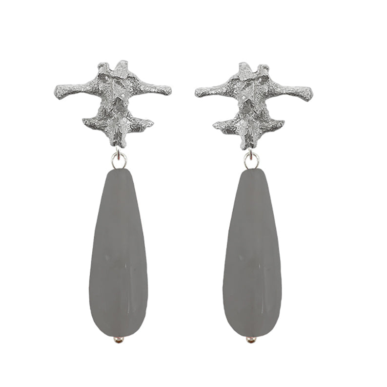 Amazon · Spine & Quartz Raindrop Earrings — Pair of earrings with star-shaped tops and teardrop-shaped gray drops on a white