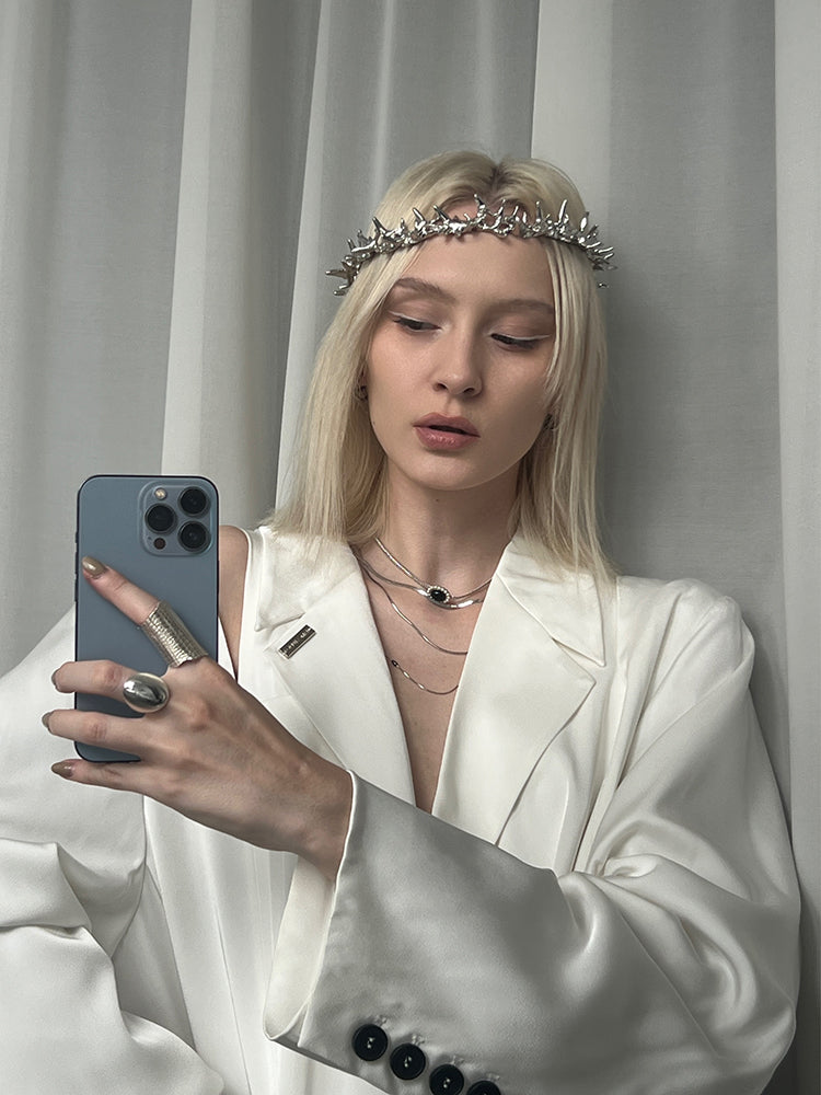 Amazon · Tilted Tower Wide Band Ring — Woman in a white outfit with a tiara taking a mirror selfie.
