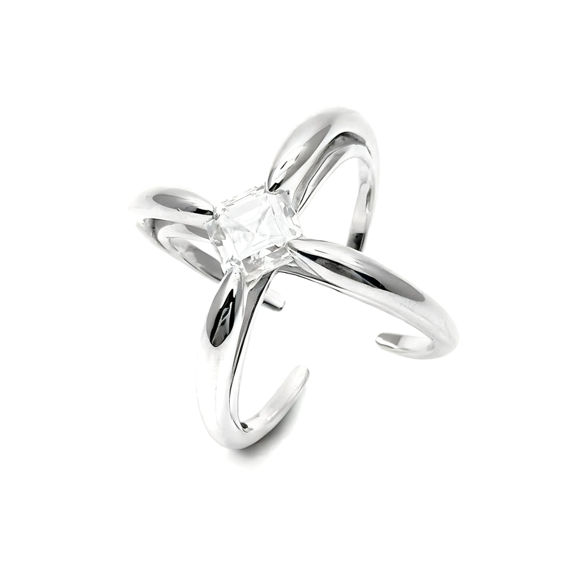 Silver cross-shaped ring with a clear gemstone on a white background