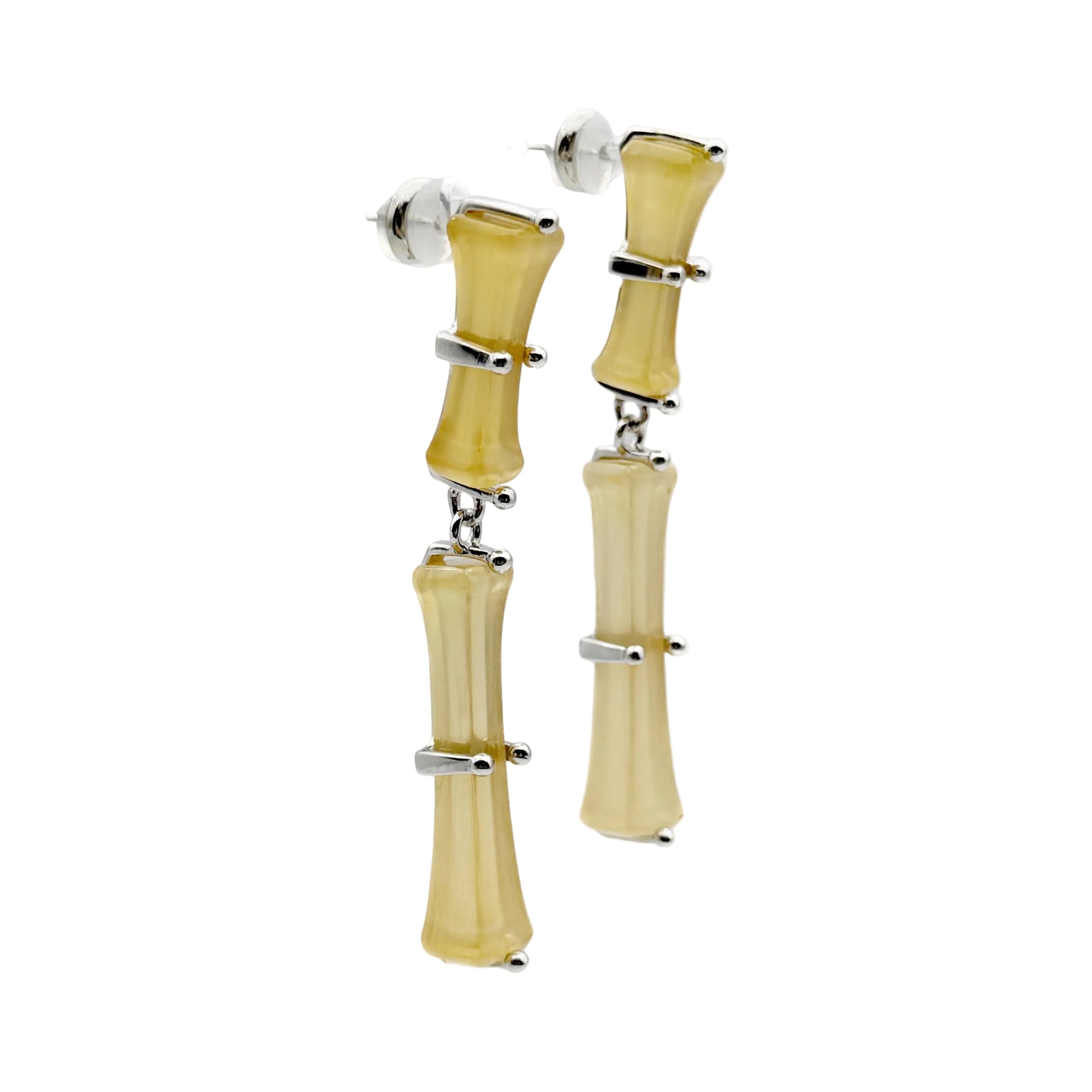 Bamboo Branch Drop Earrings — Pair of earrings with beige cylindrical design and silver accents on a white background