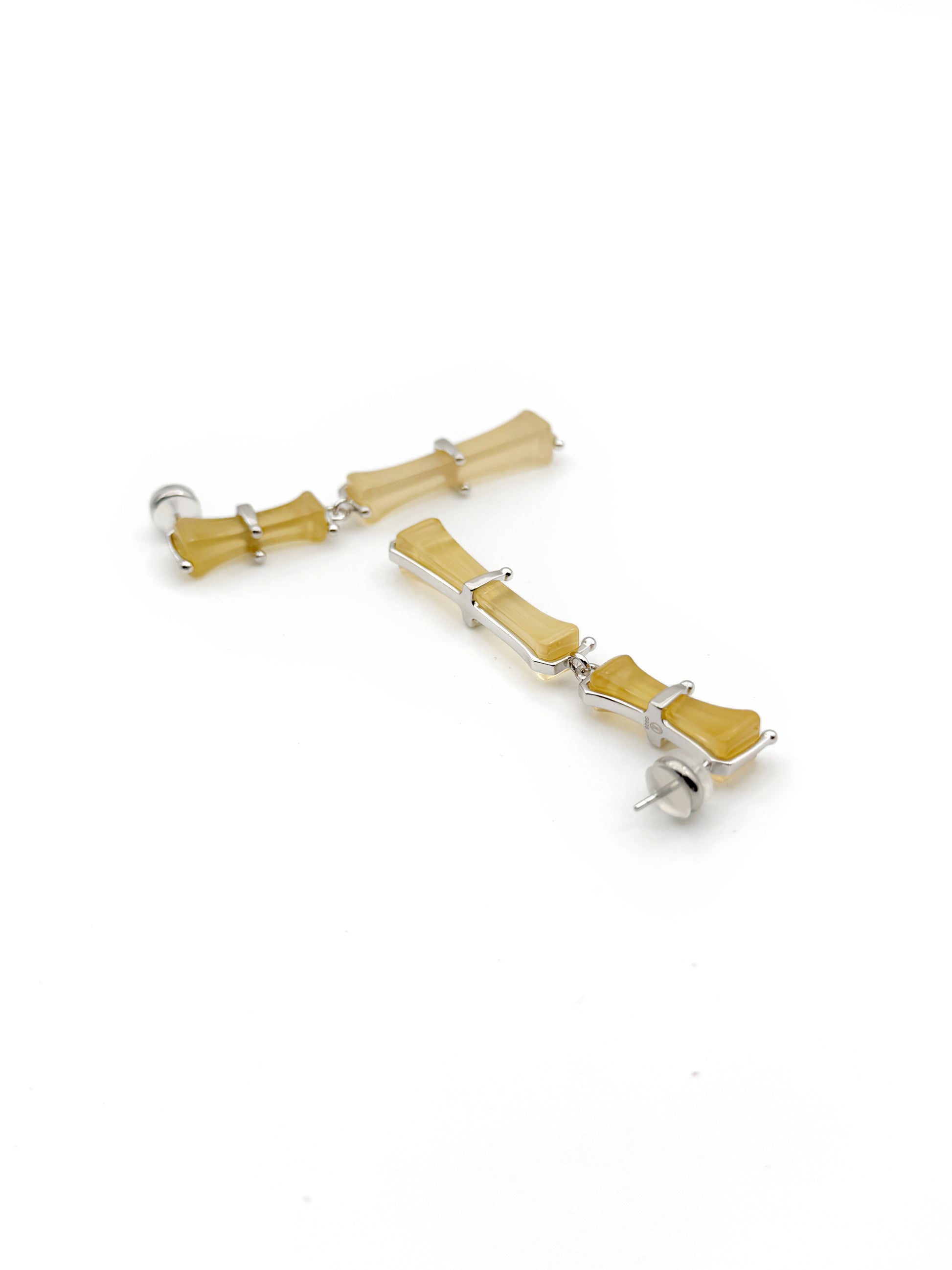 Pair of earrings with wooden elements on a white background