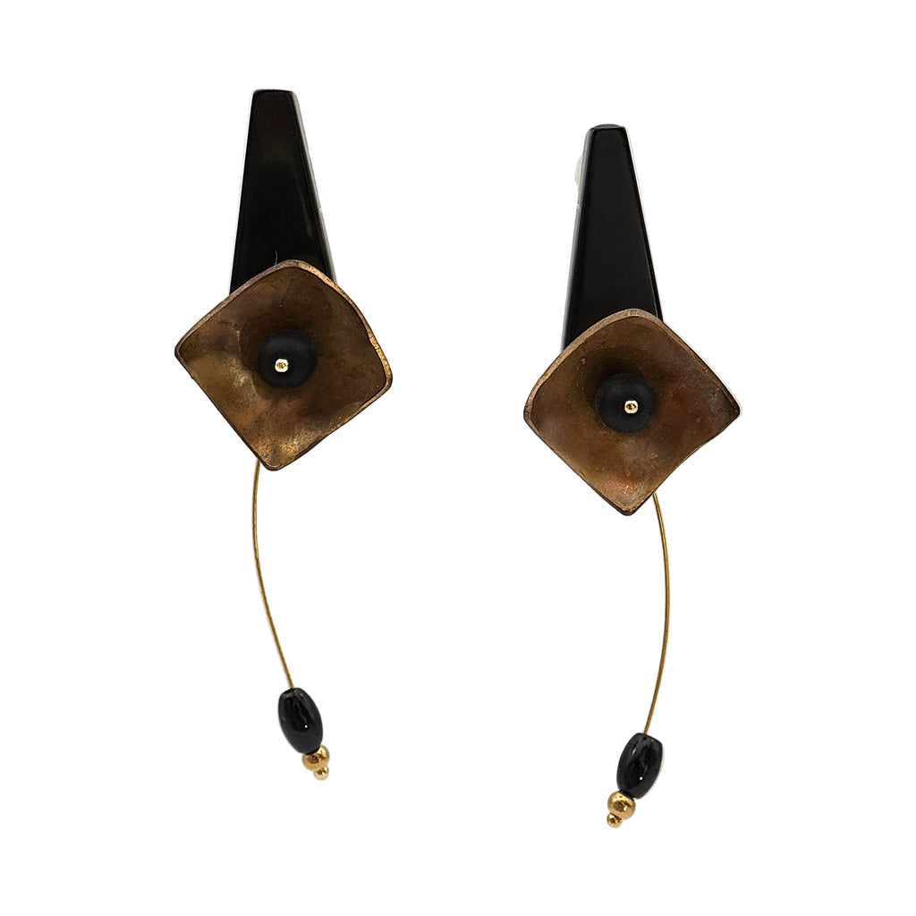 Black Hibiscus Lacquer Quasi-Maki-e Earrings — Pair of earrings with square brown stones and black beads on a white