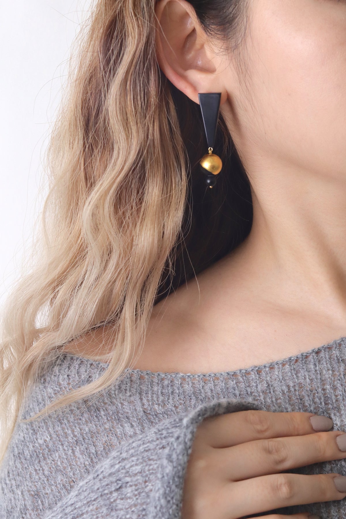 Black Mountain Lacquer Quasi-Maki-e Earrings — Close-up of a woman wearing a black earring with a gold accent.