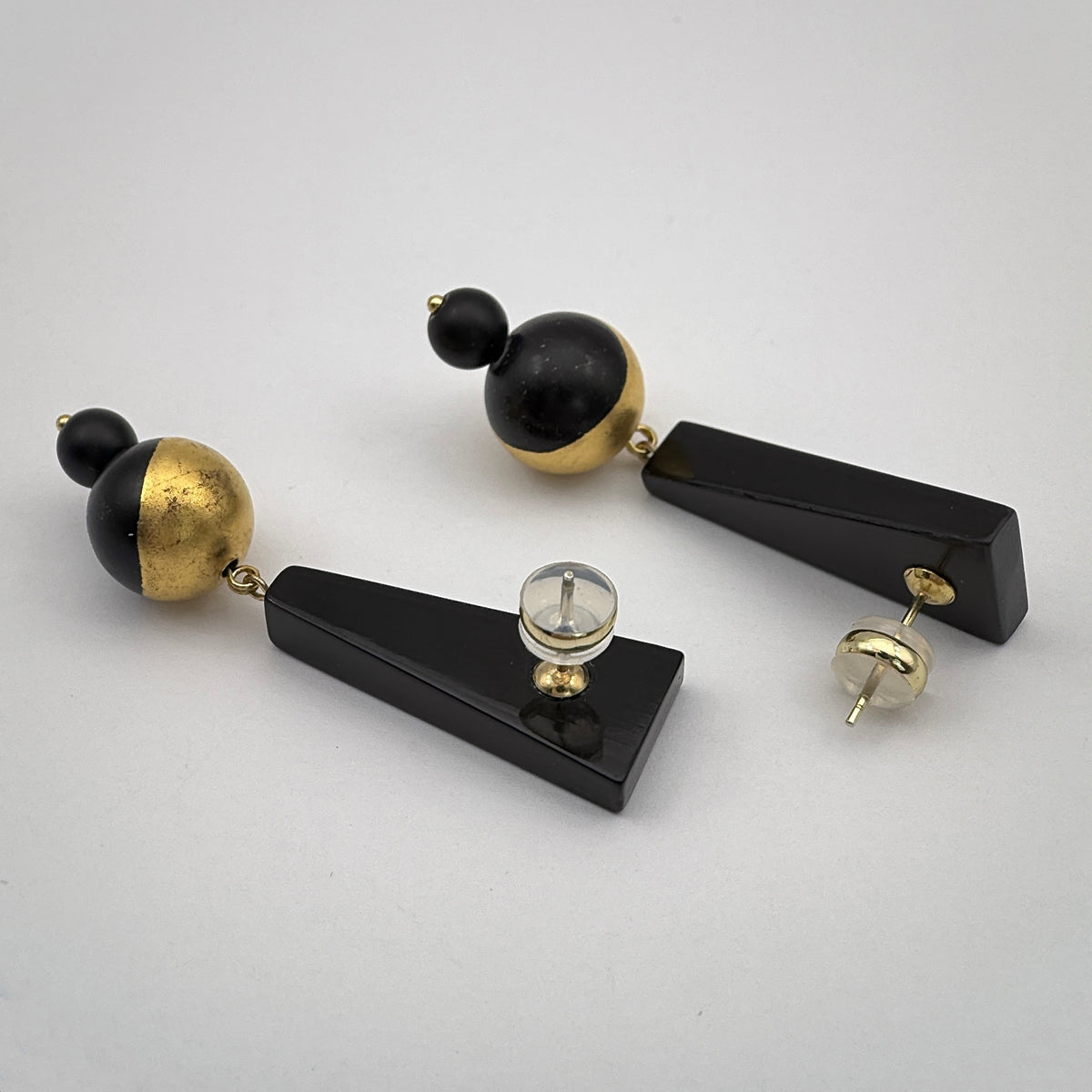 Black Mountain Lacquer Quasi-Maki-e Earrings — Pair of black and gold earrings on a light gray background
