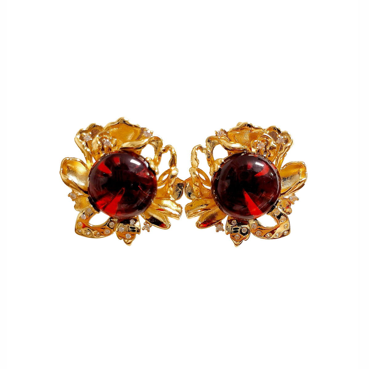 Blood Amber Flower Earrings — Pair of gold earrings with red gemstones on a white background