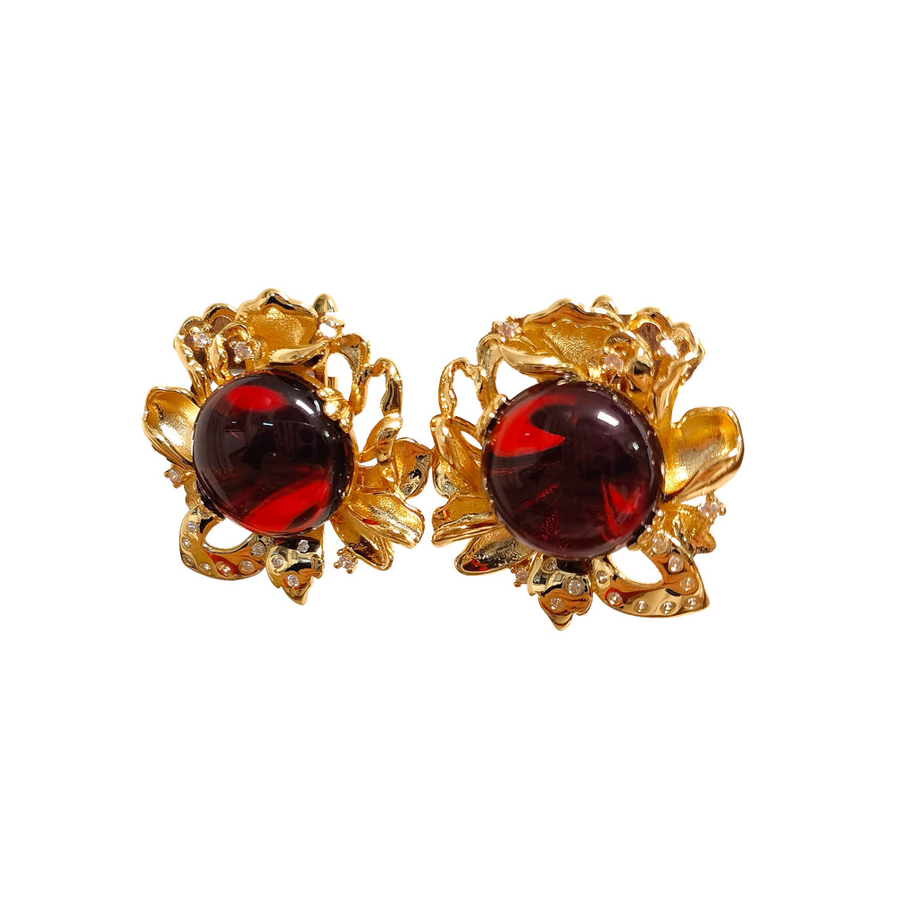Handcrafted blood amber flower earrings featuring cabochon cut amber in warm red and gold tones.