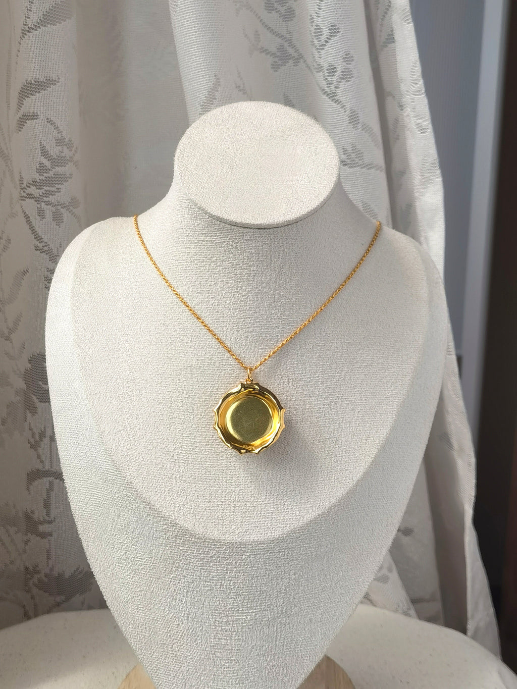 Blood Amber Flower Necklace — Gold necklace with a pendant on a white mannequin bust against a neutral background