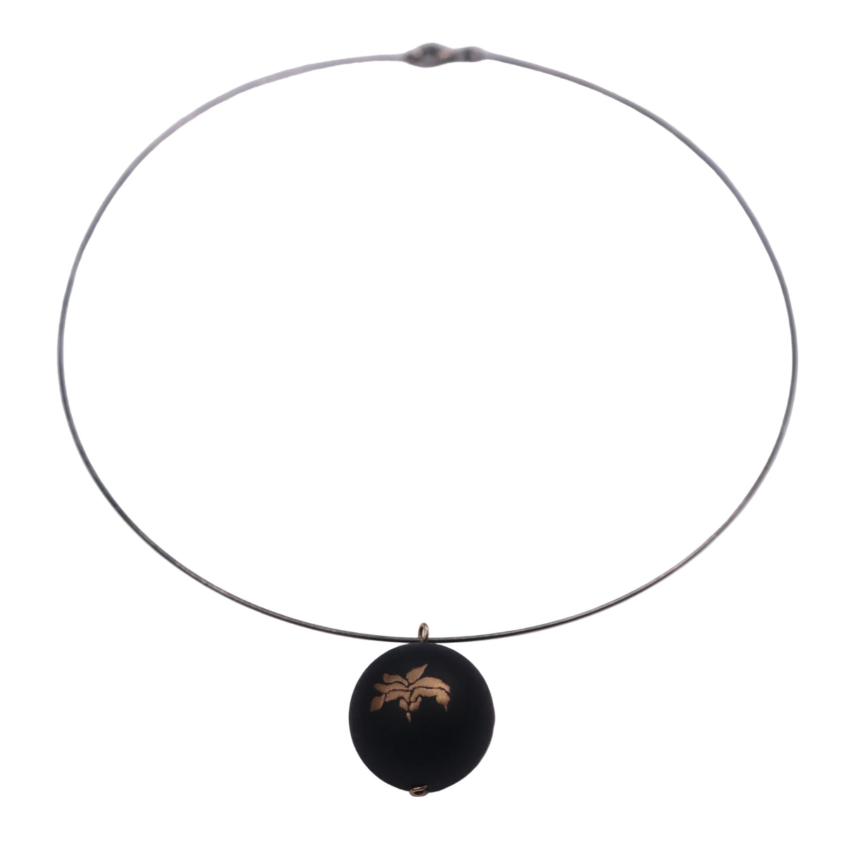 Bloom and Fade Magnolia Lacquer Quasi-Maki-e Necklace — Necklace with a black pendant featuring a gold emblem on a white