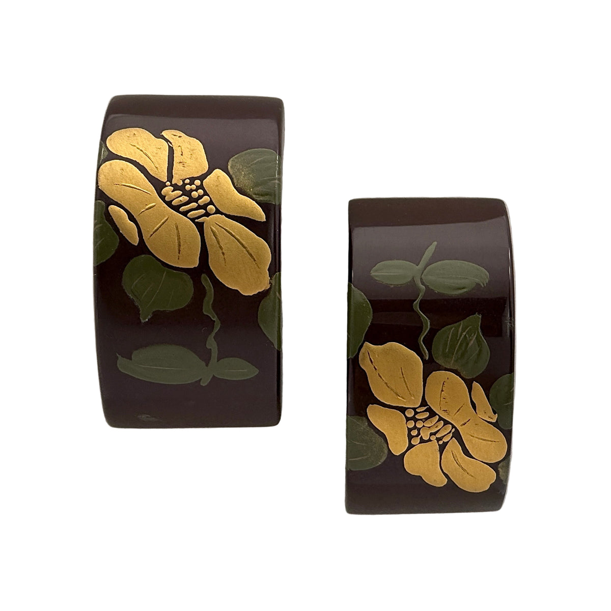 Camellia Lacquer Quasi-Maki-e Earrings — Pair of black cuff bracelets with gold floral designs on a white background