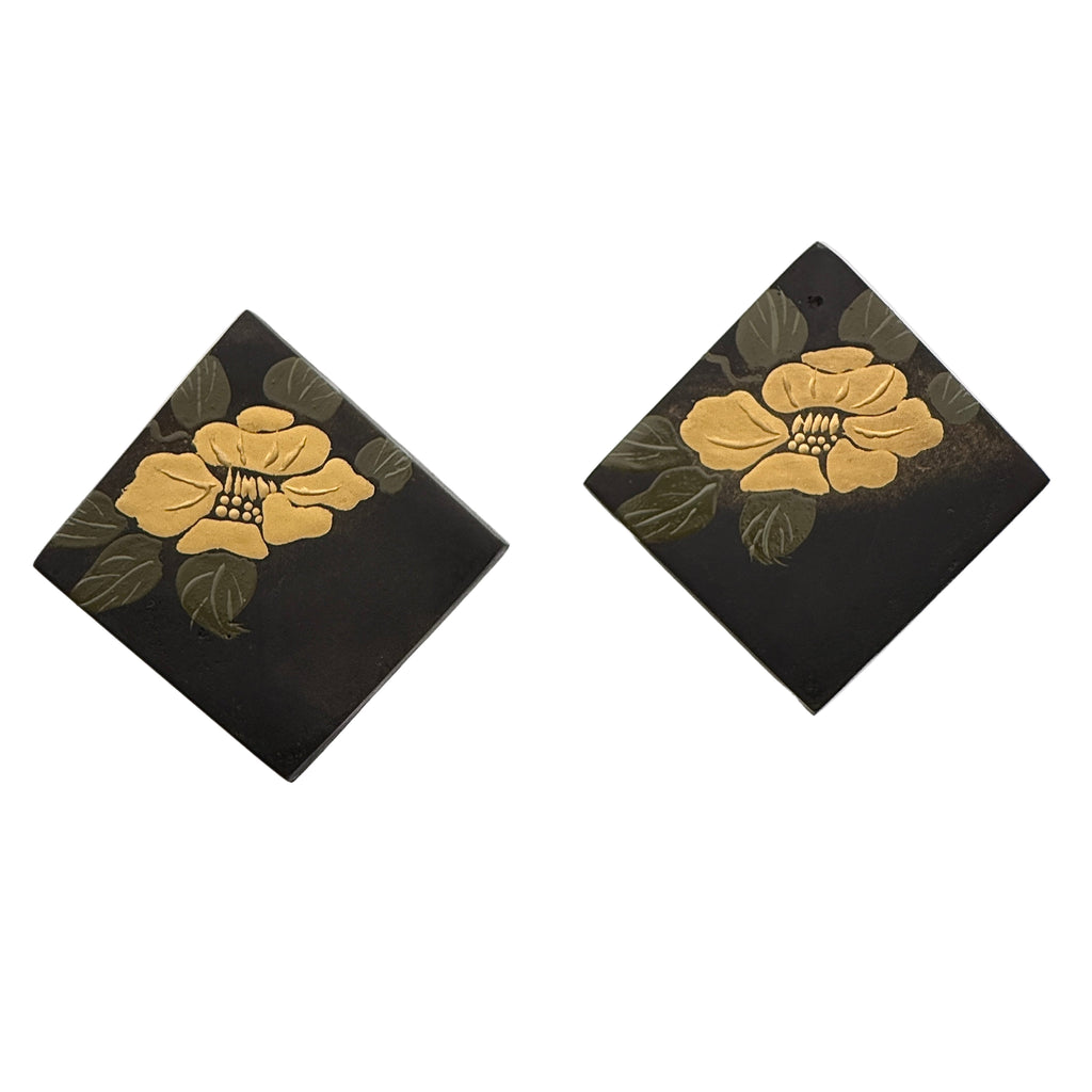 Camellia Lacquer Quasi-Maki-e Earrings — Pair of square earrings with gold floral designs on a black background