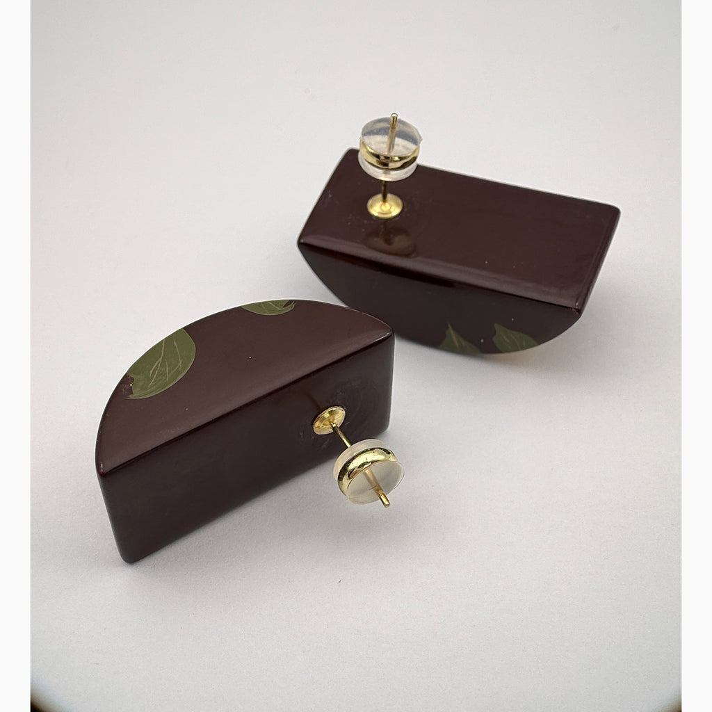 Camellia Lacquer Quasi-Maki-e Earrings — Two brown decorative boxes with gold knobs on a white background