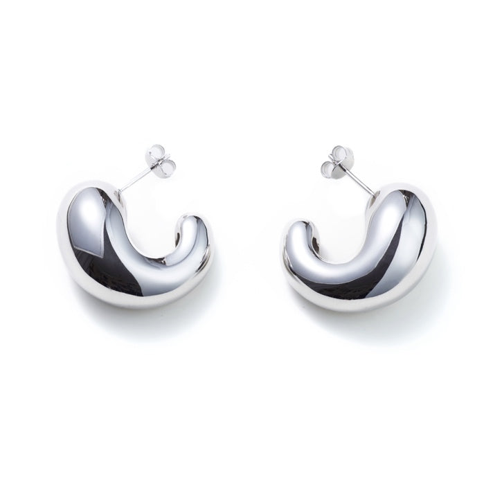 Cashew Curve Silver Earrings — Silver hoop earrings on a white background
