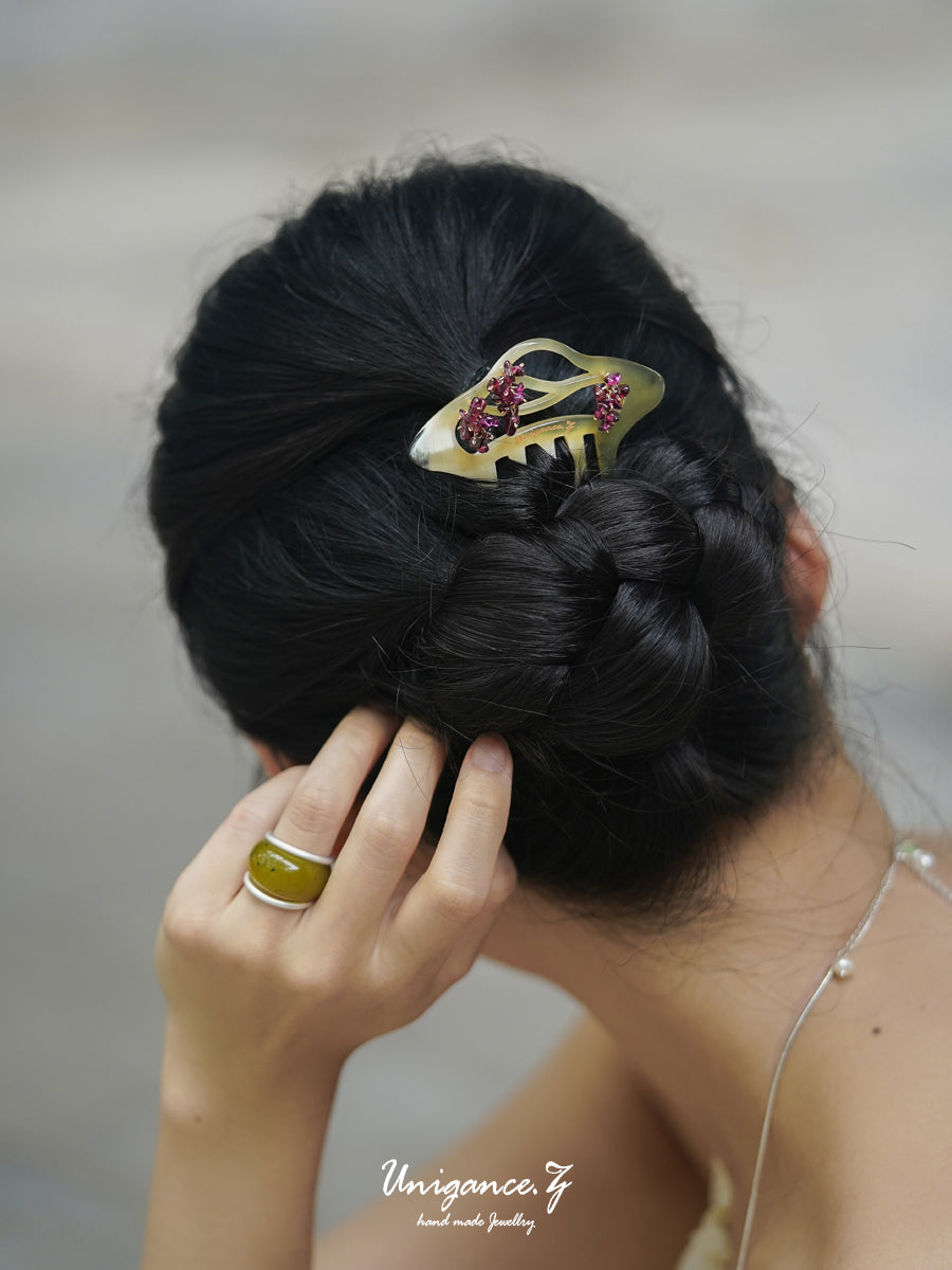 Crimson Bloom Branch Hair Comb — Close-up of a braided hairstyle with a decorative hair clip, blurred background