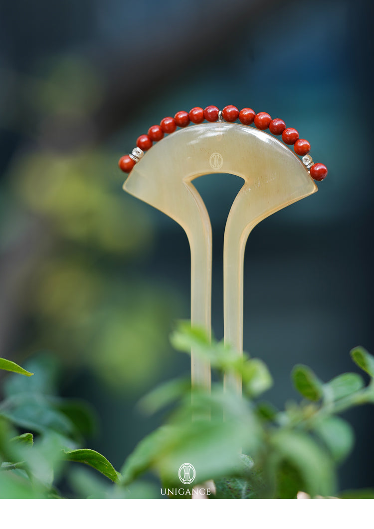 Crimson Touch Carnelian Hairpin — Decorative hairpin with red beads on a blurred green background