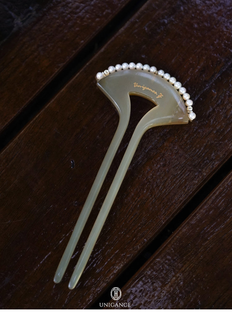 Crimson Touch Pearl Hairpin — Decorative hairpin with pearls on a wooden surface, branded 'UNIGANCE'.
