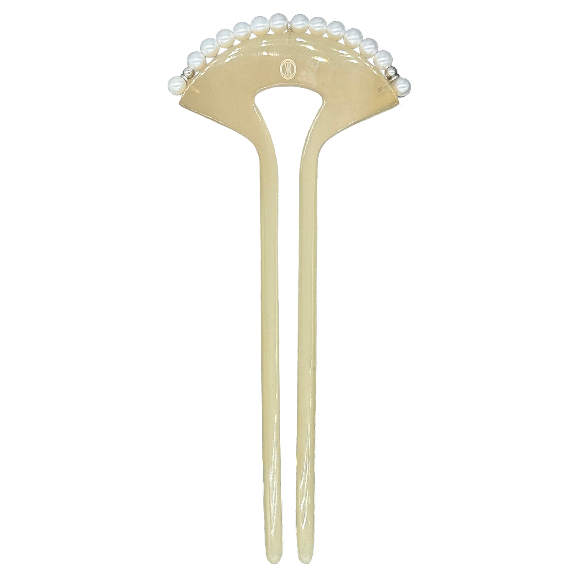 Beige hairpin with pearl-like beads on a white background