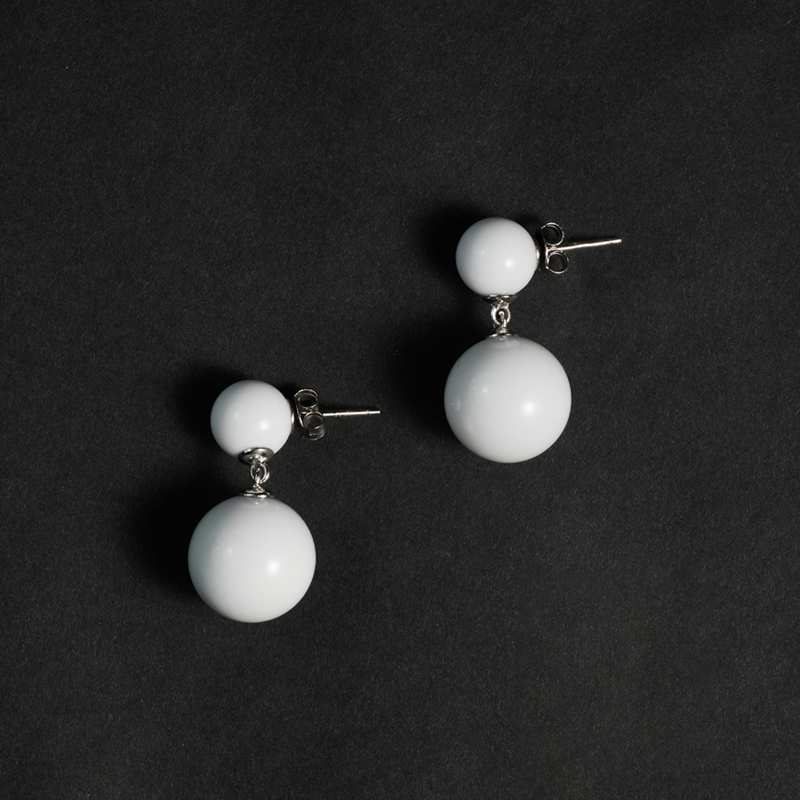 Double Sphere White Agate Earrings — Pair of white spherical earrings on a black background