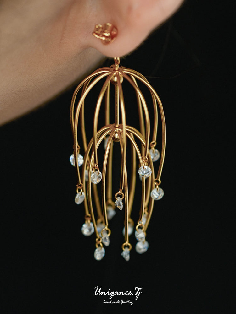 Drooping Begonia Drop Earrings — Gold earrings with pearl-like beads on a black background