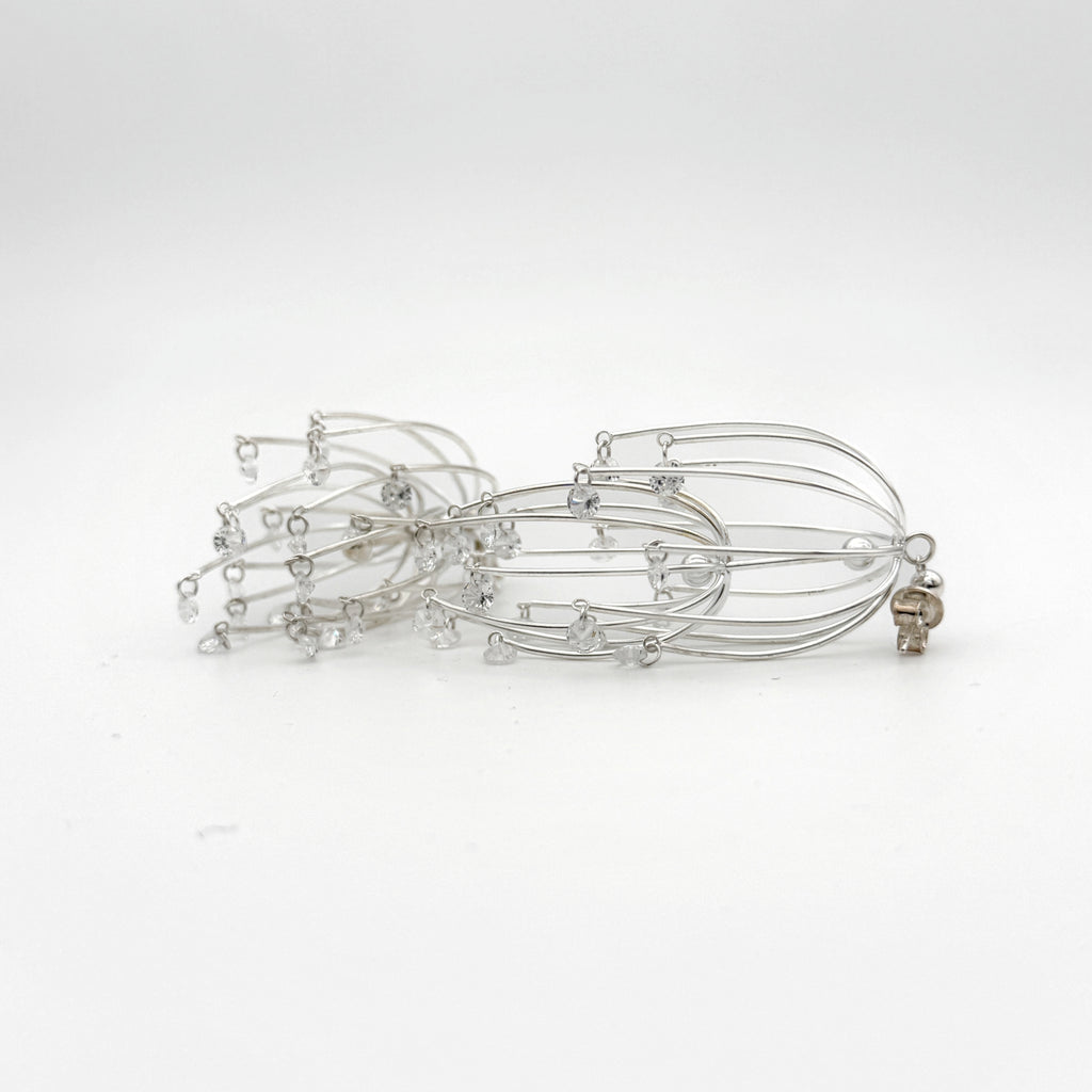 Drooping Begonia Drop Earrings — Silver hairpin with small beads on a white background