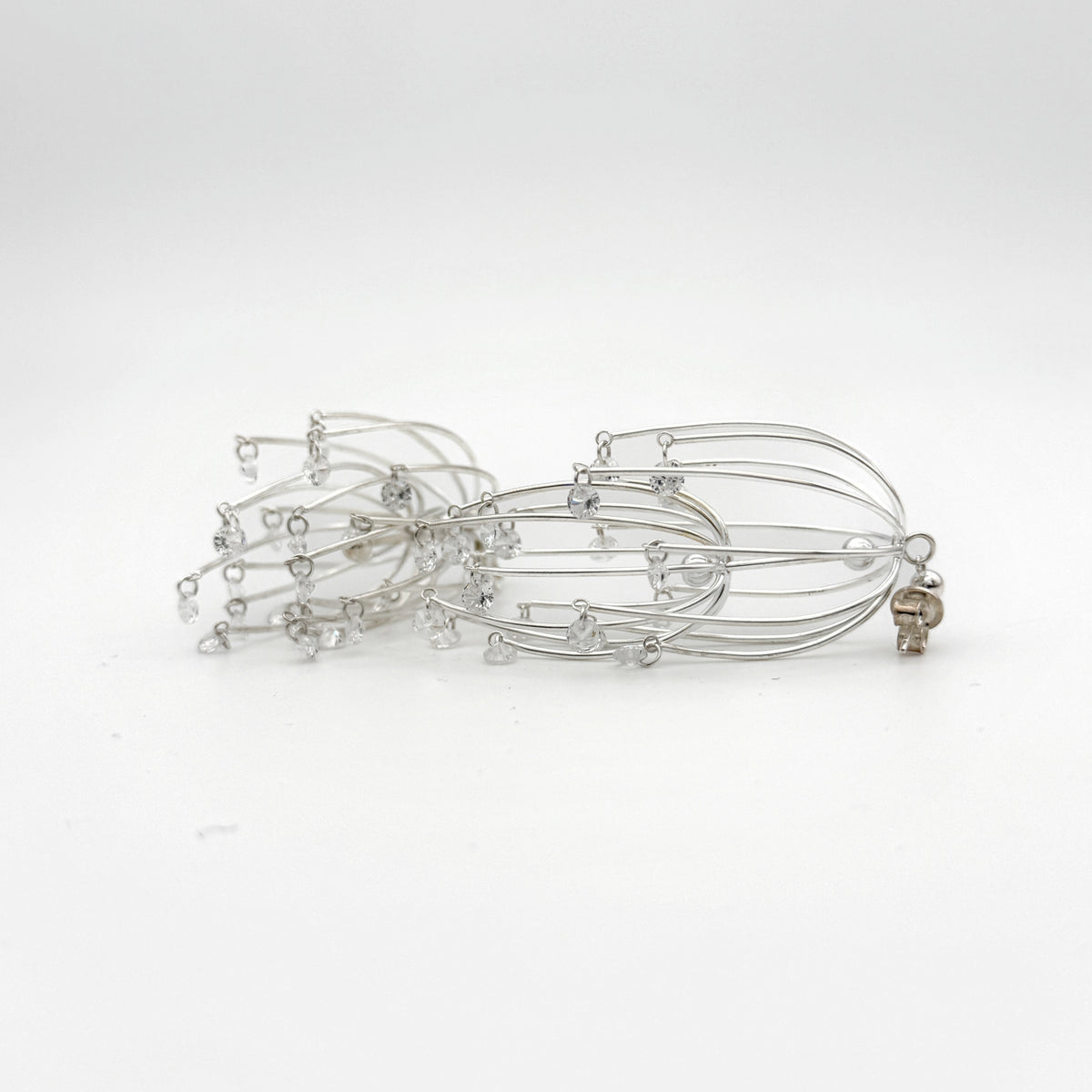 Drooping Begonia Drop Earrings — Silver hairpin with small beads on a white background