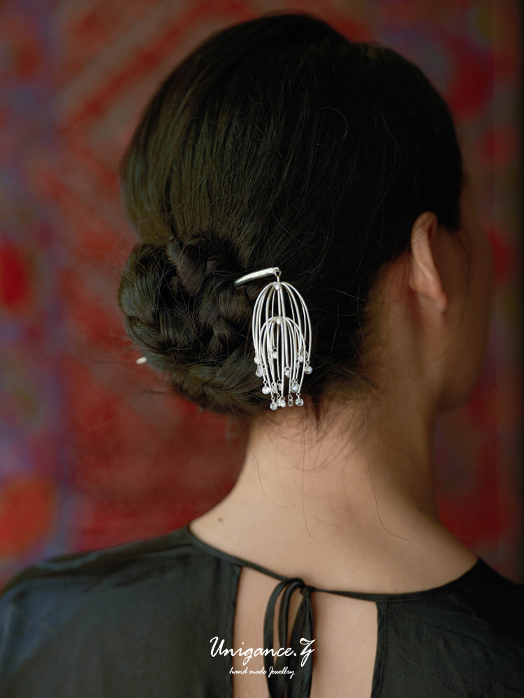 Drooping Begonia Hairpin — Person with a decorative hair clip on a colorful background