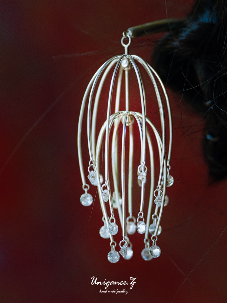 Drooping Begonia Hairpin — Silver earrings with dangling beads on a red background