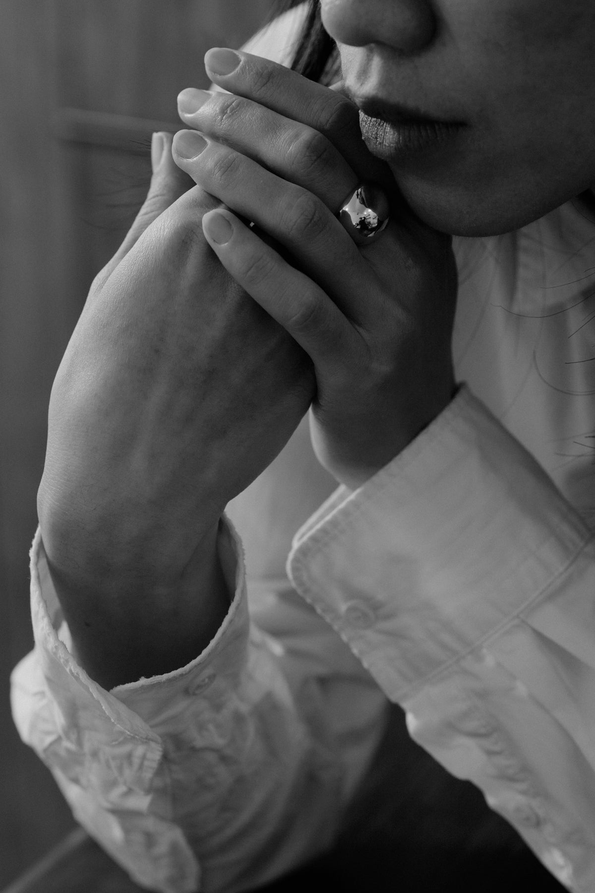 Egg Silhouette Silver Ring — Person holding a phone to their ear with a blurred background