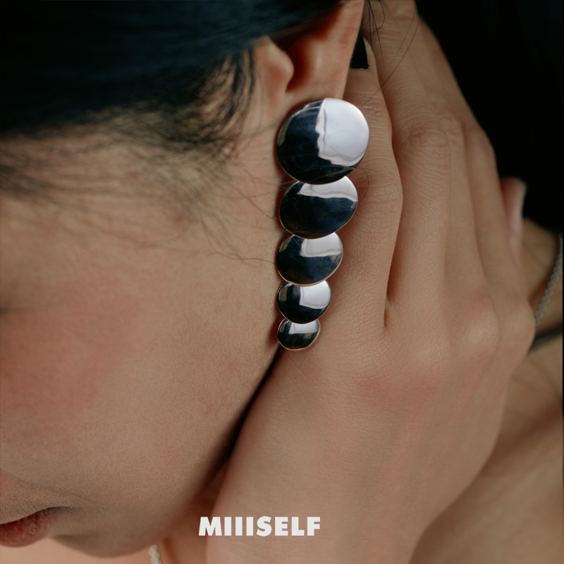 Endless Circle Disc Silver Earrings — Close-up of an ear wearing a unique earring with 'MIIISELF' branding.