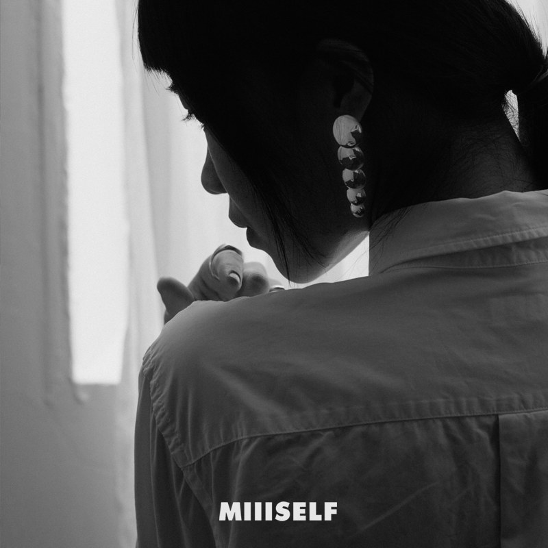 Endless Circle Disc Silver Earrings — Person holding a baby with 'MIIISELF' branding in the corner