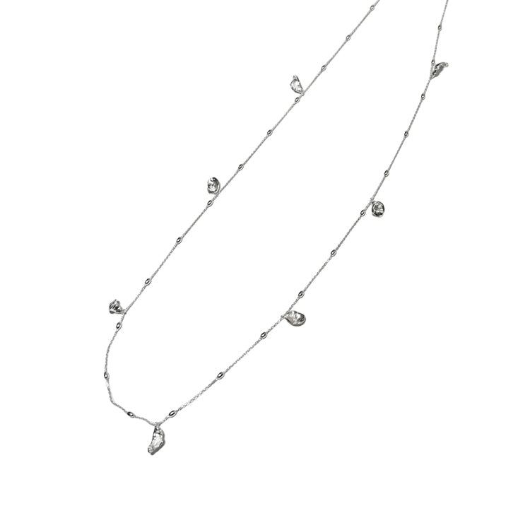 Flora & Blossom Long Necklace — Silver necklace with small pendants on a white background