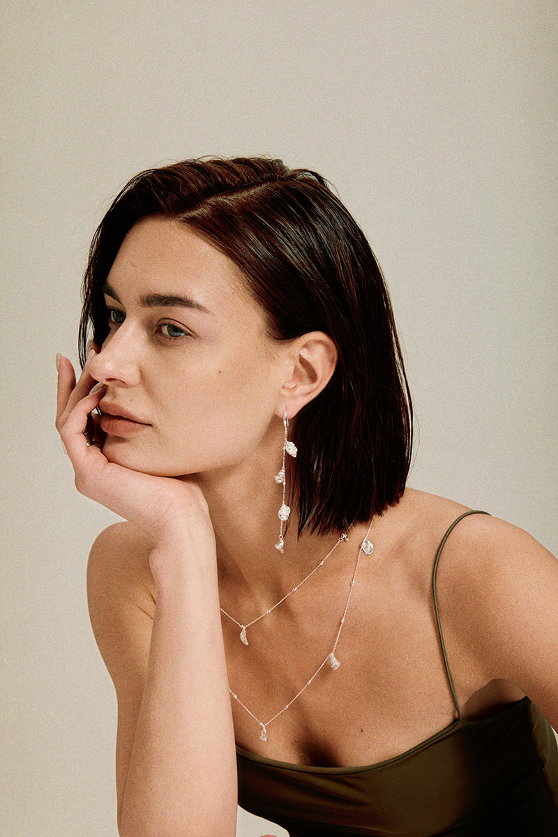 Flora & Blossom Long Necklace — Woman wearing delicate jewelry with a neutral background