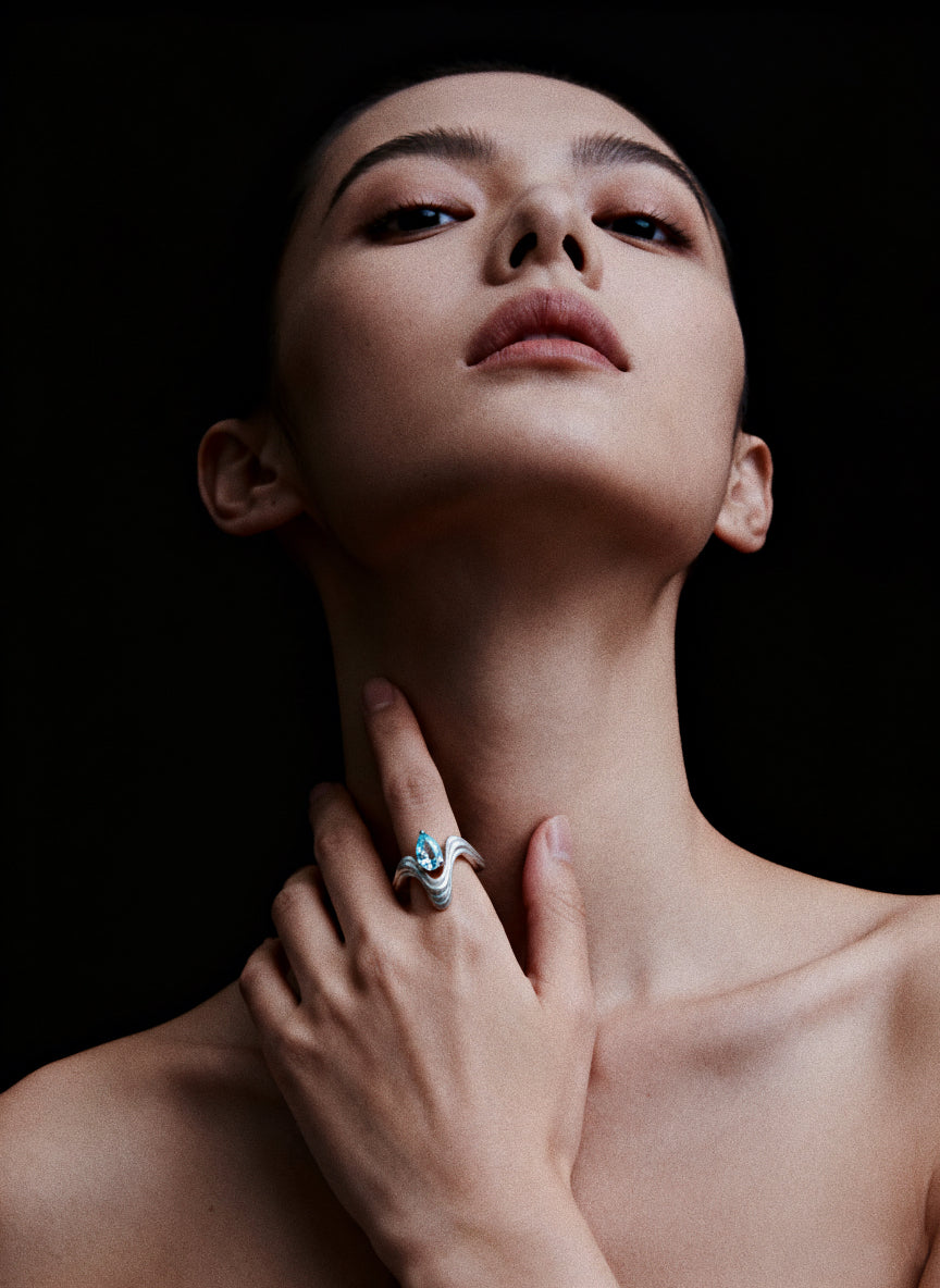 Fluid Waveform · Cubic Zirconia & Silver Ring — Woman wearing a ring on her hand with a black background
