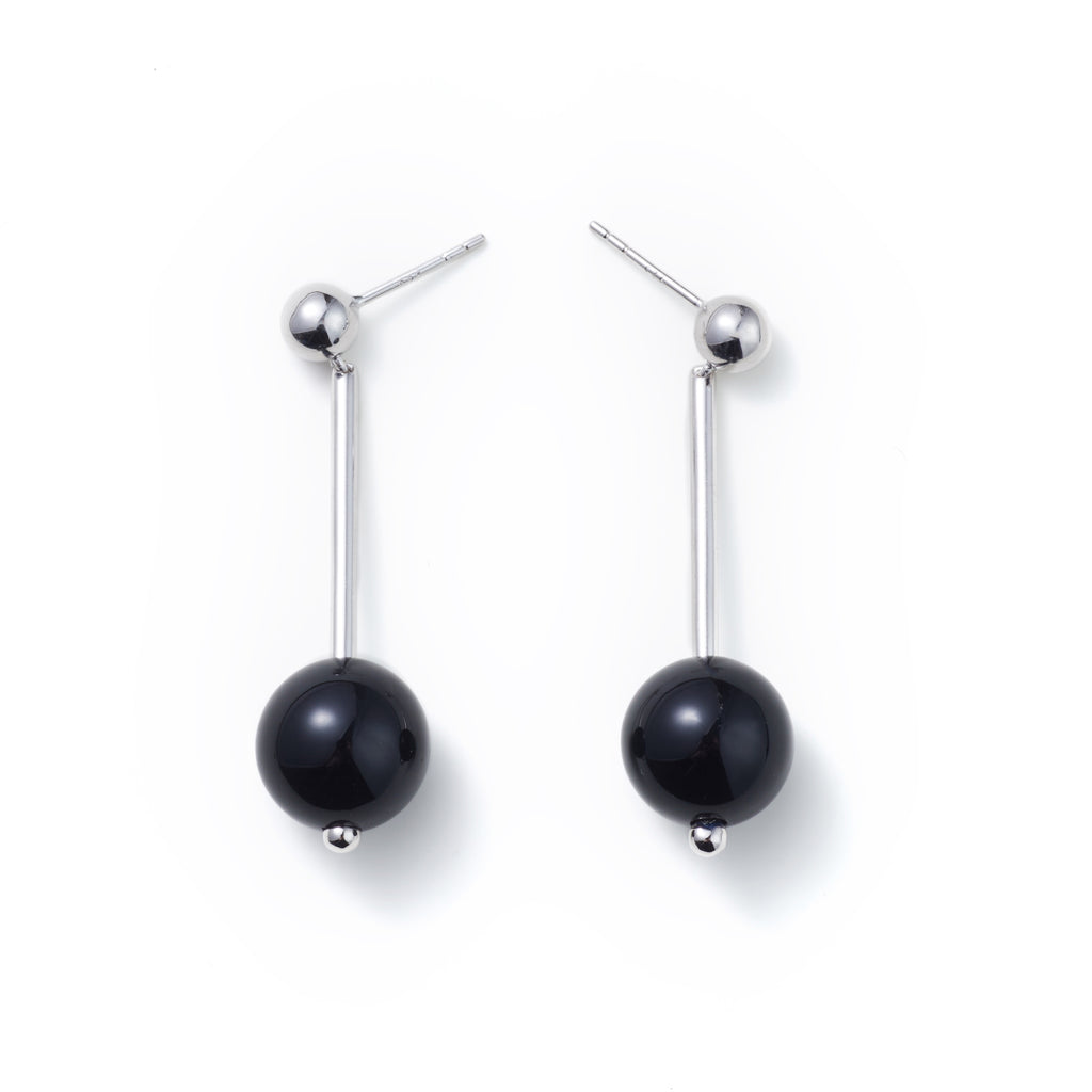 Geometric Sphere Drop Earrings — Pair of black pearl earrings on a white background