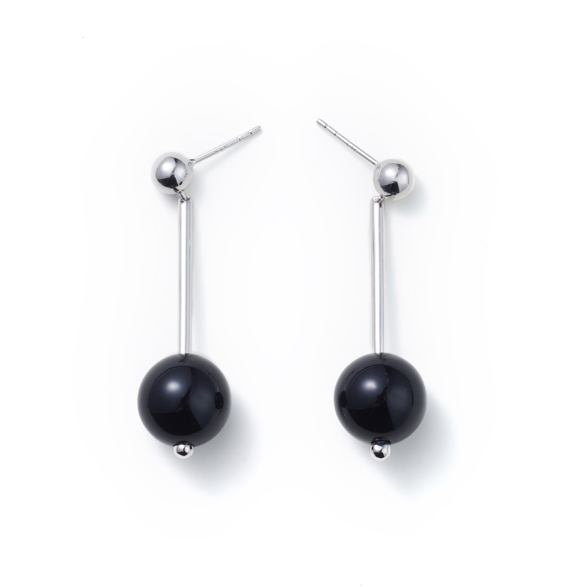 Geometric Sphere Drop Earrings — Pair of black pearl earrings on a white background