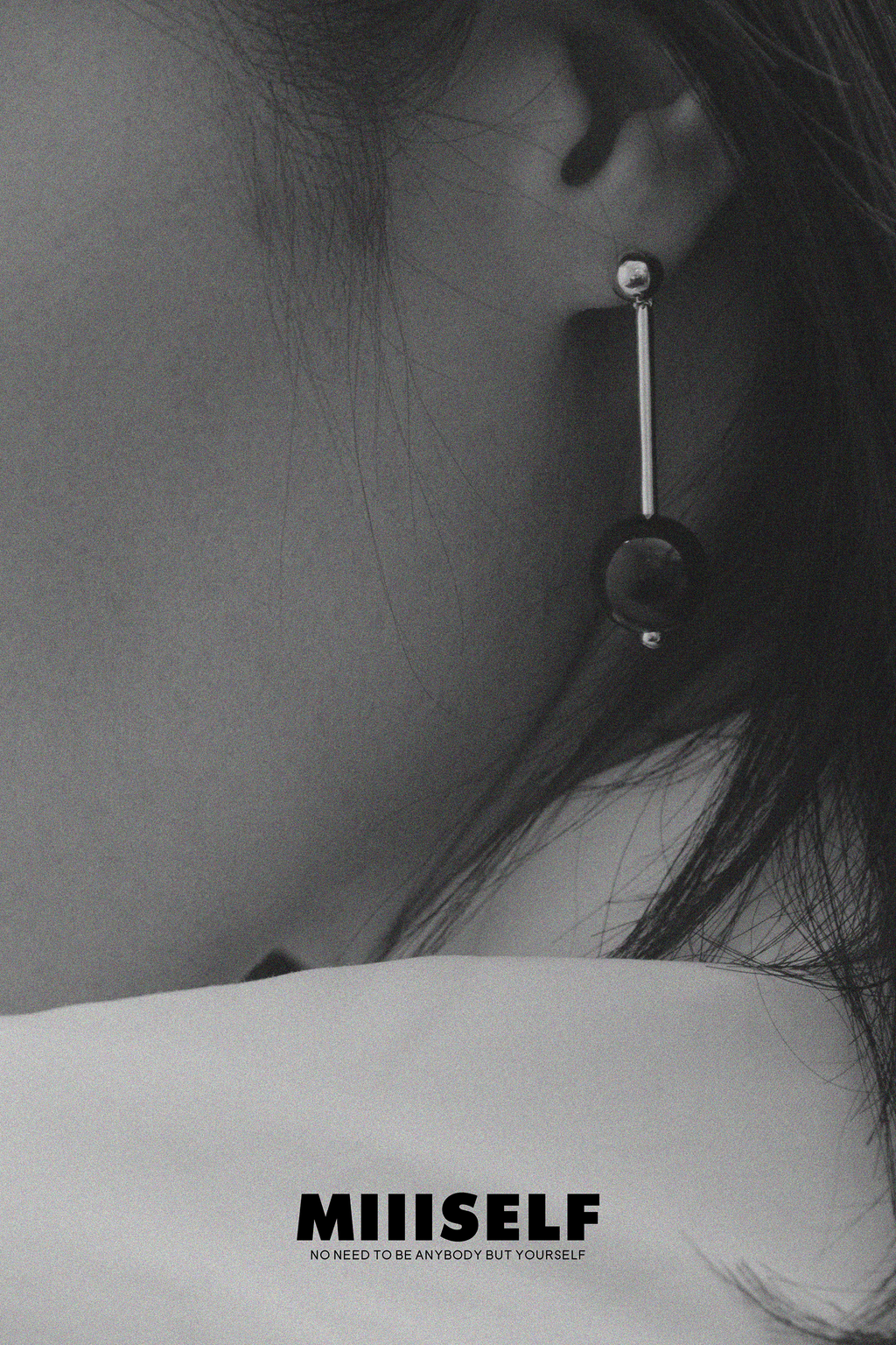 Geometric Sphere Drop Earrings — Close-up of an ear with a unique earring, featuring the brand 'MIIISELF'.