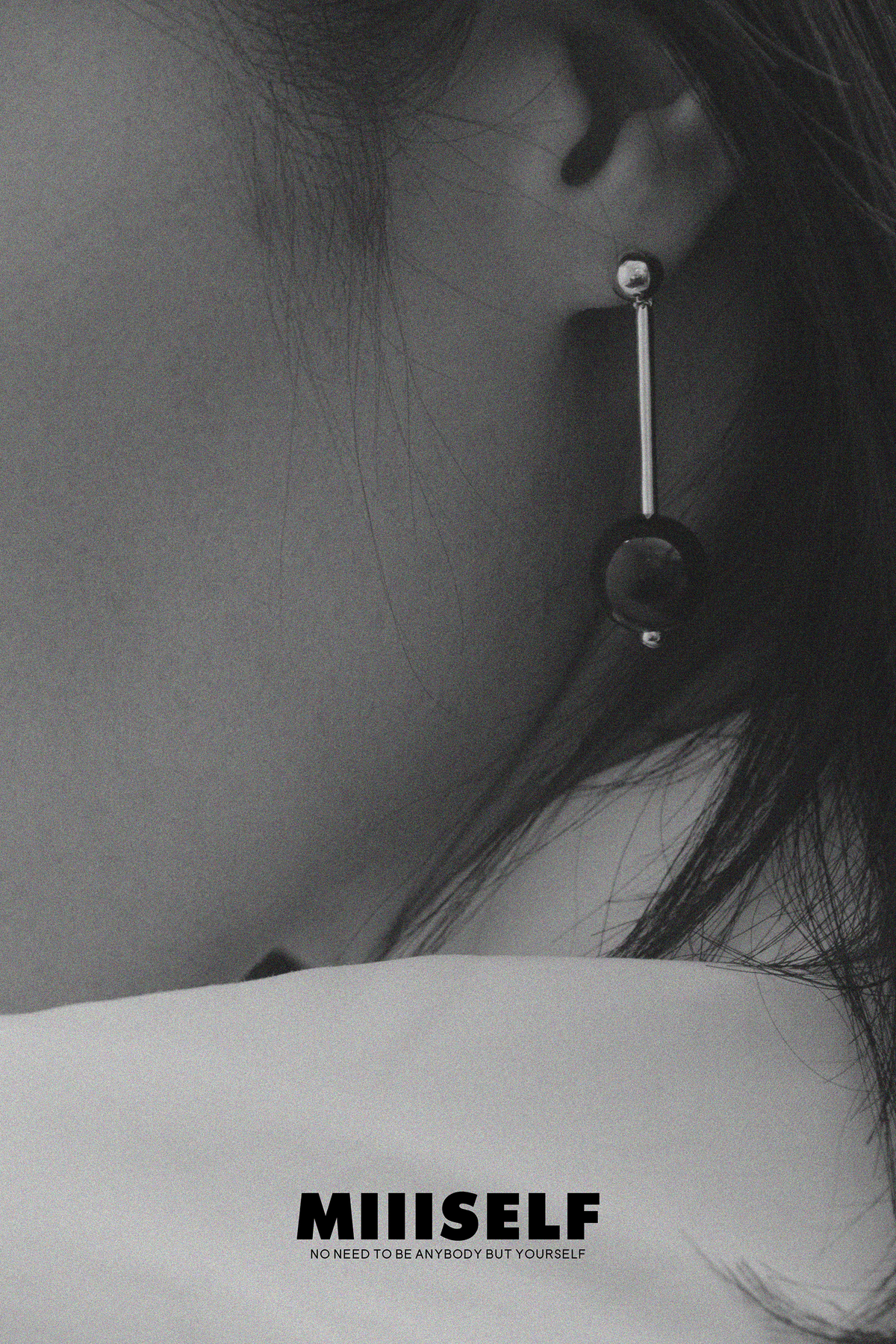 Geometric Sphere Drop Earrings — Close-up of an ear with a unique earring, featuring the brand 'MIIISELF'.