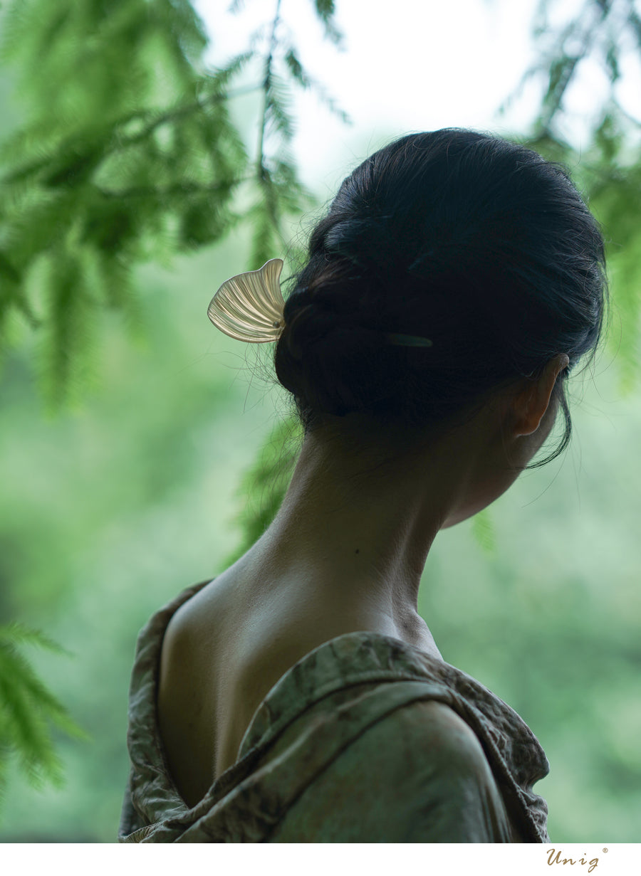 Ginkgo Leaf Hairpin — Person with dark hair and green shirt standing in a forest