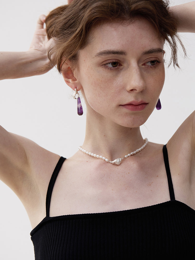 Gold Digger · Gemstones Teardrop Earrings — Woman wearing a black top with a plain background