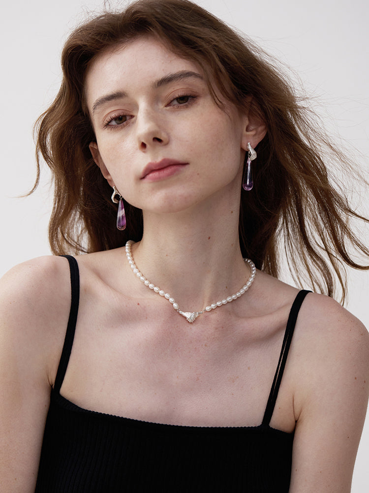 Gold Digger · Gemstones Teardrop Earrings — Woman wearing a pearl necklace and earrings against a plain background