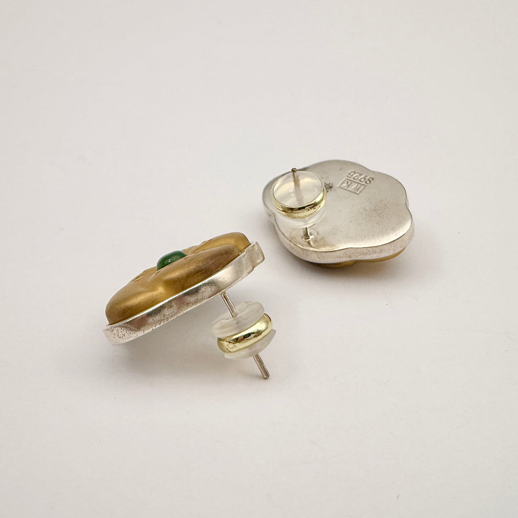 Golden Peach Blossom Lacquer Quasi-Maki-e Earrings — Pair of silver and gold earrings with a green gemstone on a light gray