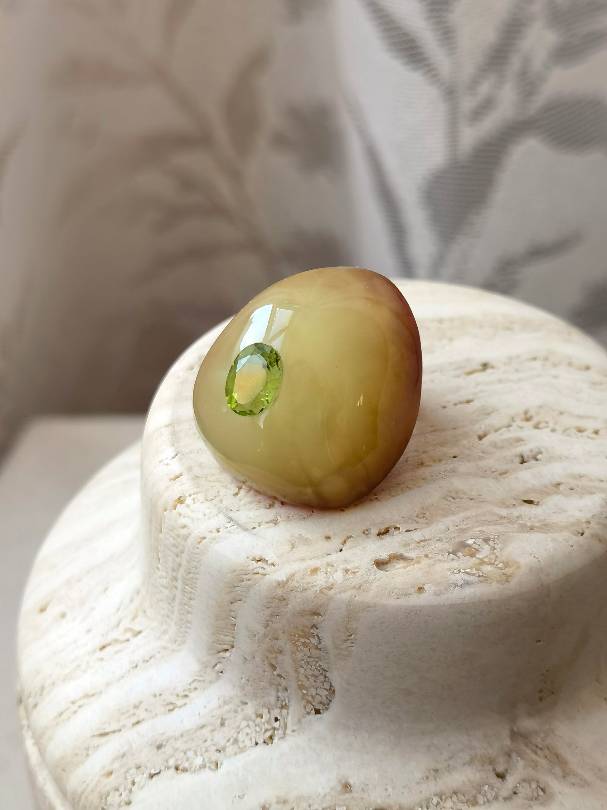 One of a kind amber brooch combining organic amber texture with the gentle vitality of peridot.