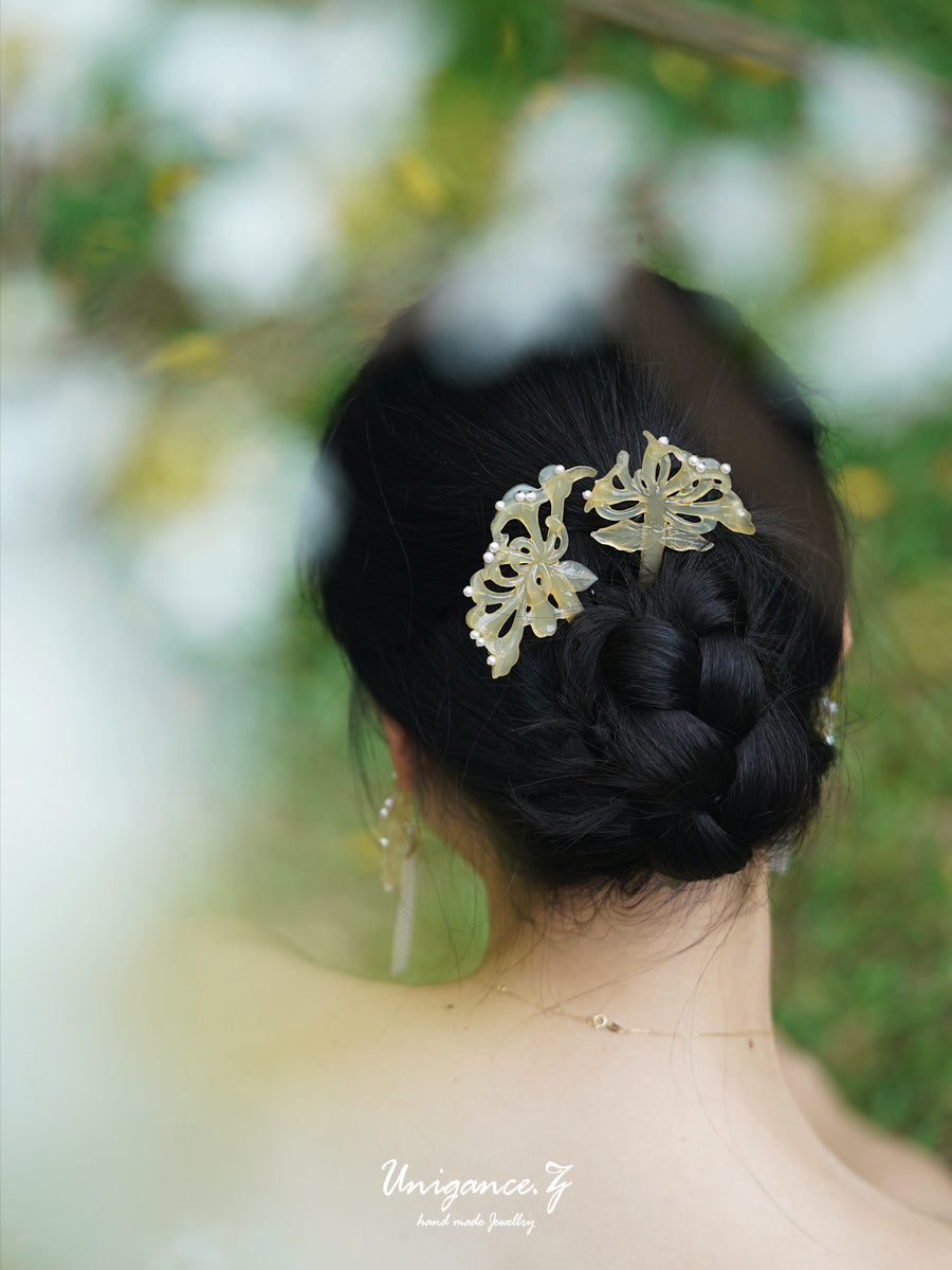 Honeysuckle Pearl Hairpin — Person with braided hair wearing decorative hairpins against a blurred natural background